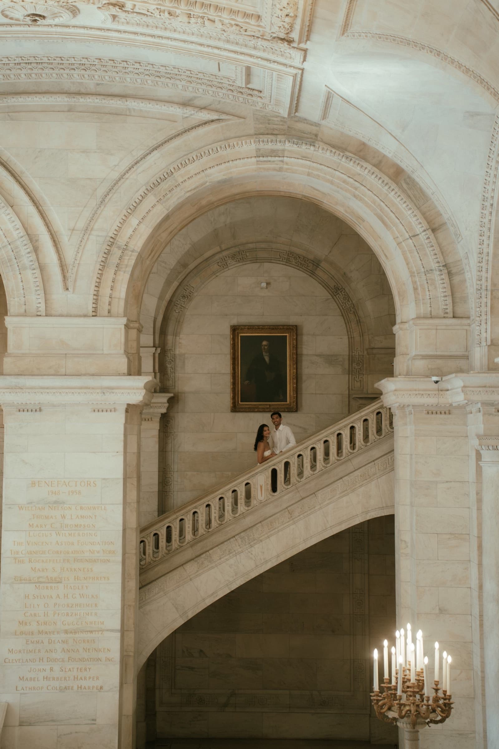 Ananya and Varun standing together on a grand marble staircase